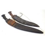 Two 19th century Indian / Nepalese kukris in leather scabbards, lacking skinning tools. Largest with