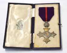 Cased Military type 1 Britannia OBE medal in Garrad & Co case
