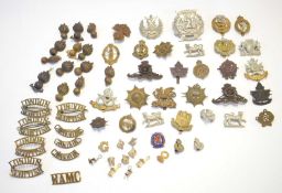 Quantity of 20th century cap badges and brass shoulder titles to include ww1 British women’s