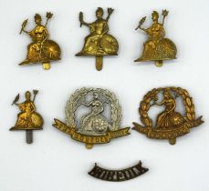 Quantity of Royal Norfolk Regiment cap badges and Shoulder title to include bi-metal examples