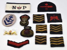 Quantity of Royal Naval cloth insignia to include ERII Naval Police arm band, ERII Naval Dolphin