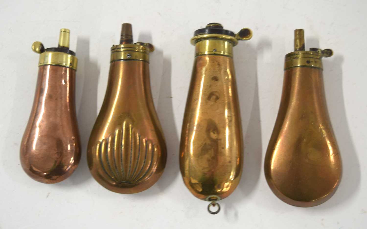 A quantity of four unnamed brass and copper 19th century pistol powder flasks all in varying - Image 2 of 2