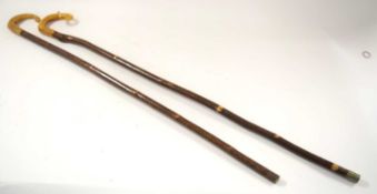 Two shepherds crook walking stick / stalking sticks with horn handles. One example 125cm and other