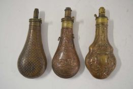 Three 19th century copper powder flasks to include: a copper bodied powder flask with star motif