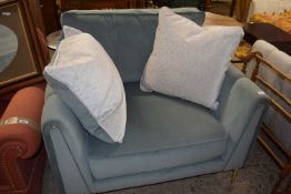 A modern oversize armchair with two cushions