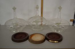 Group of three novelty glass models of aircraft contained in bulbous decanter style surrounds,