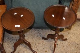 A pair of reproduction mahogany wine tables with circular tops