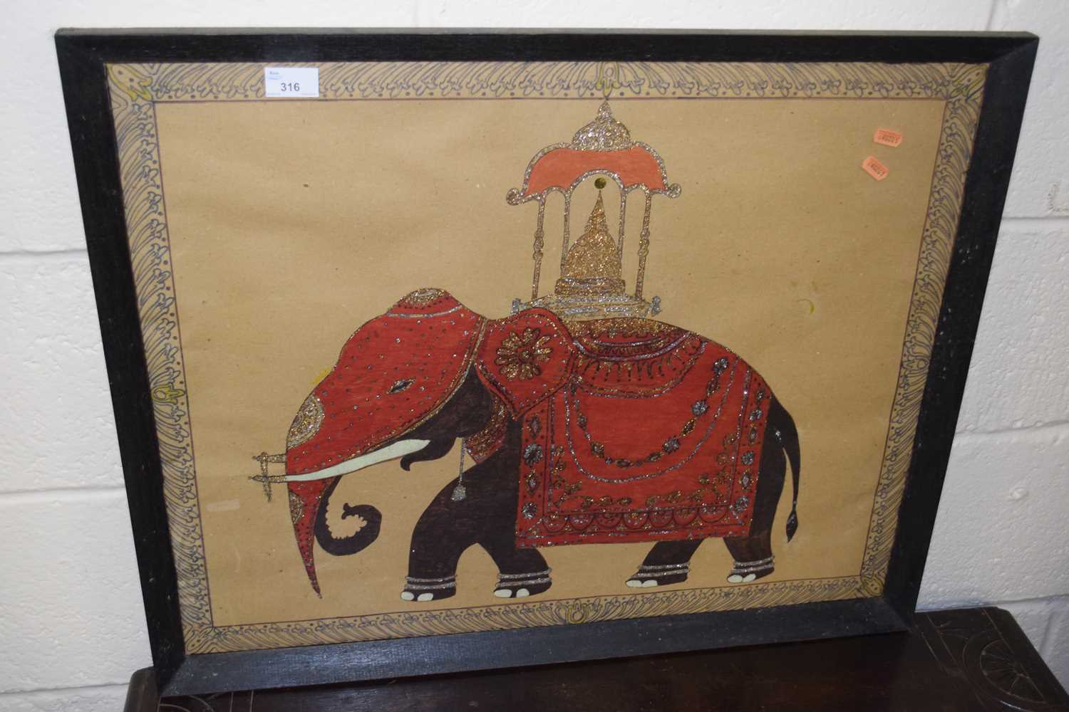 A needlework picture of a Indian elephant in procession dress, framed and glazed