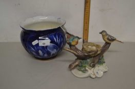 A Capodimonte figure of two birds at a nest together with a blue and white jardiniere