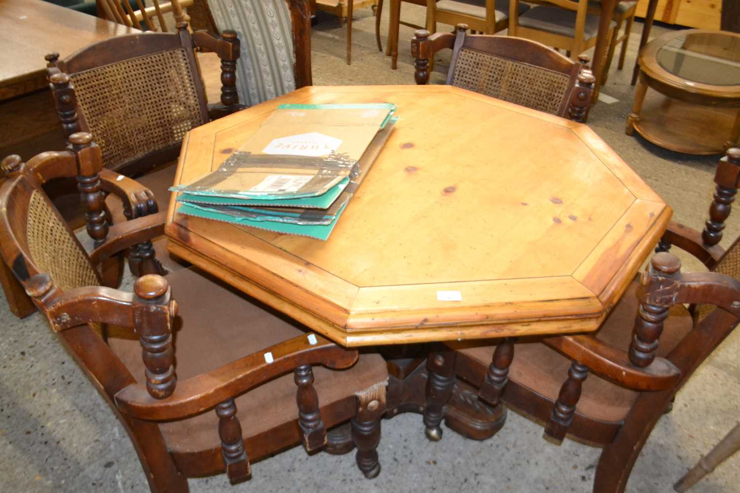 An octagonal pine pedestal table together with a set of four cane back chairs, table 105cm wide (5)