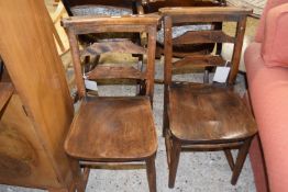 A pair of late 19th Century elm seated chapel style chairs