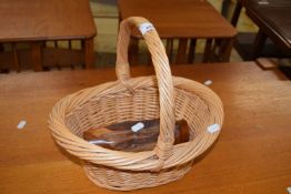 A small wicker basket and a turned wooden vase (2)