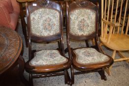 A pair of early 20th Century rocking chairs with floral upholstery