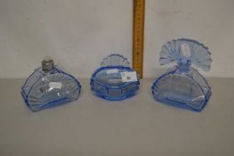 A pale blue glass three piece dressing table set in the Art Deco style