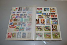 A stock book of various world stamps, first day covers and various loose
