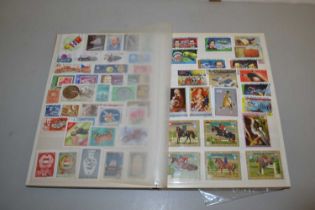 A stock book of various world stamps, first day covers and various loose