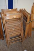 Nine various folding wooden chairs