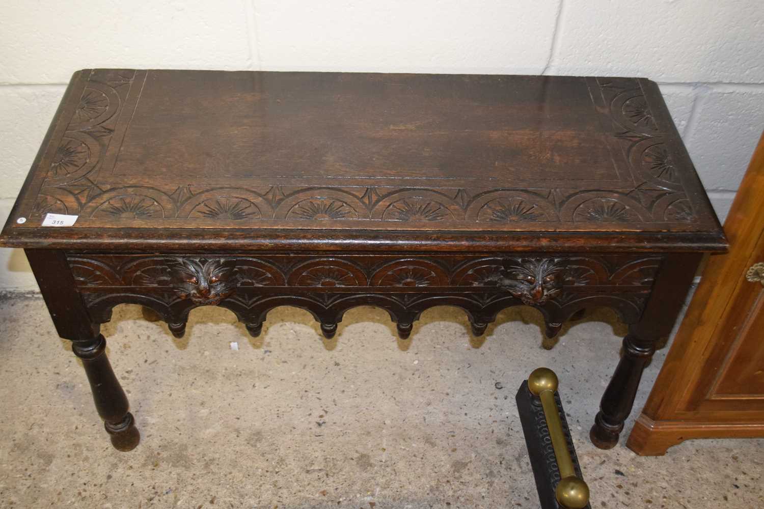 A small carved oak side table with lion mask handles (Item 5 on vendor list)