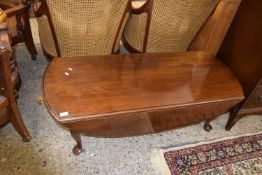 A reproduction mahogany drop leaf coffee table
