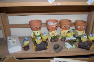 Four novelty plant pot holders together with a quantity of bird figurines and two motion activated