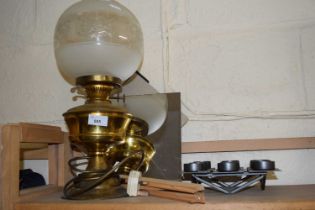 An oil lamp with glass shade converted for electricity together with tea light holder a mirror