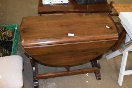 A small oval drop leaf table