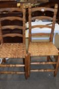 A pair of rush seated ladder back chairs