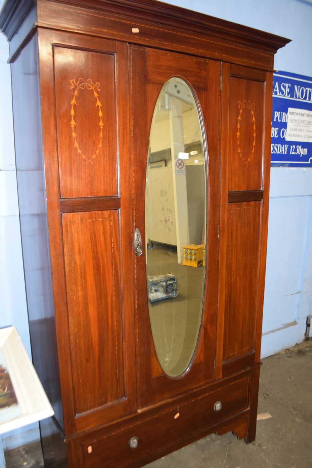 An Edwardian wardrobe with mirrored door
