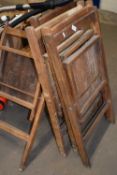 Five folding wooden chairs
