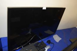 A Toshiba flat screen TV with wall mounting bracket