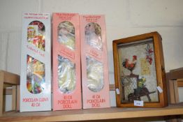Three boxed porcelain dolls together with a boxed diorama