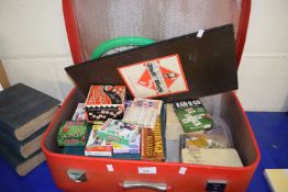A red Antler suitcase and a quantity of various games