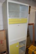 A mid 20th Century yellow and white kitchen cabinet