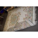Cream ground floral decorated wool rug, approx 3m square