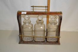 Victorian walnut and brass mounted tantalus (no key present and decanters chipped, no makers mark