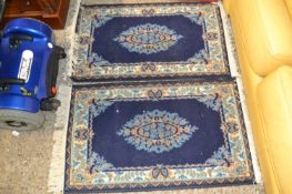 Pair of small blue floor rugs