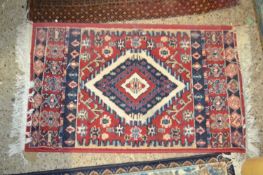 Small red patterned floor rug