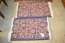 Pair of small modern blue and red floor rugs