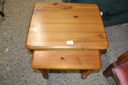 A nest of two pine tables