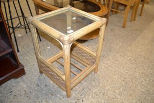 A bamboo framed glass top occasional table