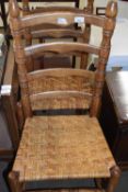 A pair of ladder back rush seated chairs