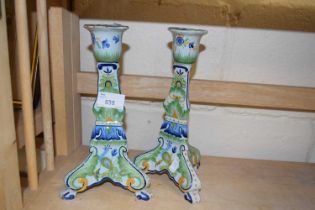 A pair of continental pottery candlesticks