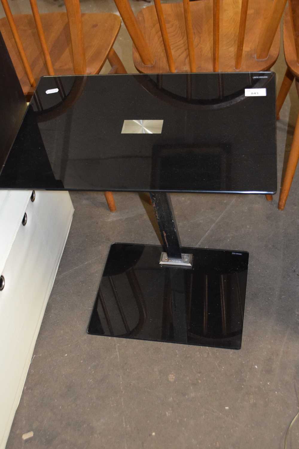 A black tempered glass side table
