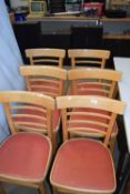 A set of six pine and vinyl seated kitchen chairs
