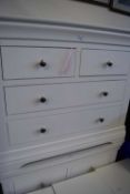 A pair of white chest of drawers with two short and two long