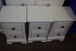 A set of three two drawer chest of drawers