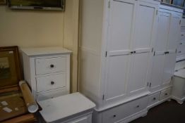 A white double wardrobe with drawer below together with another similar, a five drawer chest of