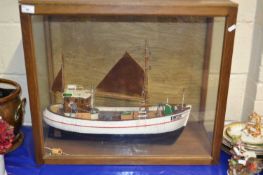 Model of a small boat set in a glazed case
