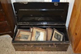 Metal trunk containing various framed black and white photos