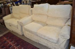 A pair of modern cream covered sofas